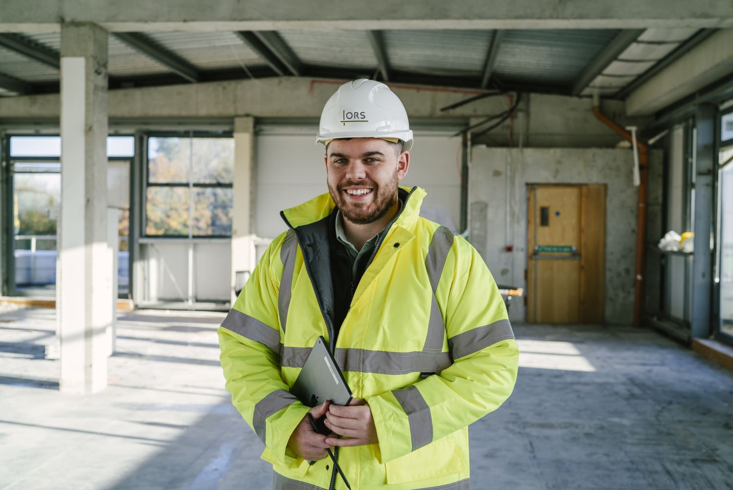 Construction professional reviewing a modern building project with a focus on energy-efficient design